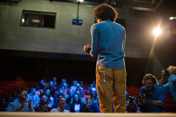 Audience watching speaker on stage