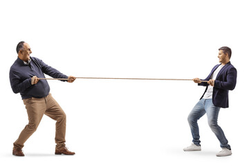 Full length profile shot of a a mature man and a young man pulling a rope
