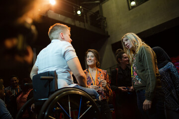Speaker in wheelchair talking to conference audience