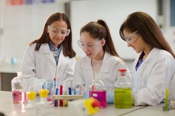 Girl students conducting scientific experiment in laboratory classroom