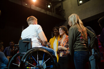 Fototapeta na wymiar Speaker in wheelchair talking to conference audience