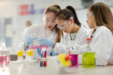 Girl students conducting scientific experiment in laboratory classroom