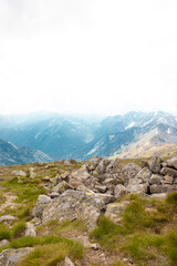 Large cobble stones on the hillside. Landscape with green blue mountains, hills and clouds in the sky, scenic outdoor travel background. Tatra National Park