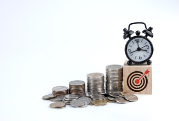 Saving money. Setting financial goals for interest growth and capital gains. Pile of coins and wooden blocks with bullseye icon. with copy space and business design