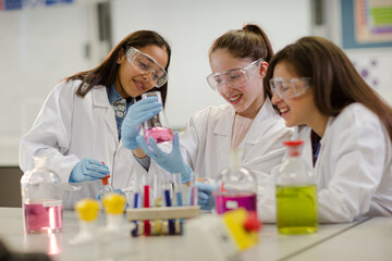 Girl students conducting scientific experiment in laboratory classroom