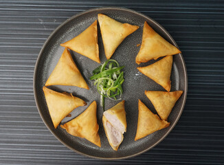 deep fried crispy yam taro spring roll samosa on dark grey wood background dim sum halal menu