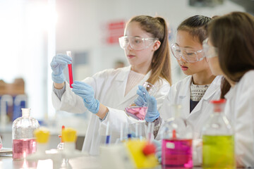 Girl students conducting scientific experiment in laboratory classroom