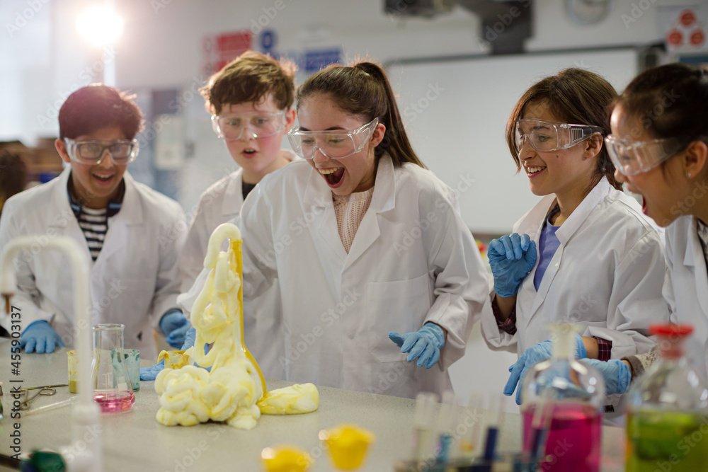 Wall mural surprised students conducting exploding foam scientific experiment in classroom laboratory