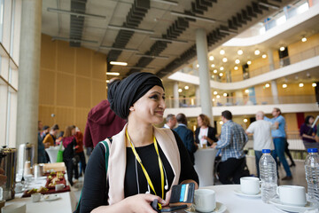 Smiling woman in hijab during conference break
