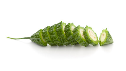 Close-Up of Organic Indian bitter gourds (Momordica charantia) or fresh Green Karela, cross section or Horizontal sliced, isolated over white.