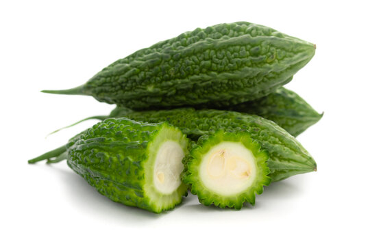 Close-Up of Organic Indian bitter gourds (Momordica charantia) or fresh Green Karela, cross section or Horizontal sliced, isolated over white.
