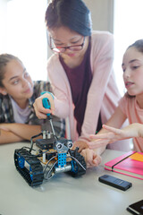 Students playing with robot in classroom