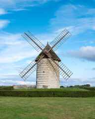 Fototapeta na wymiar old windmill in french normandy under blue summer sky