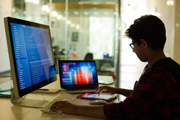 Student boy using computer at desk