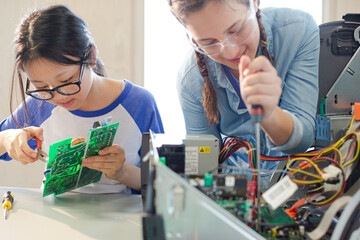 Girl students assembling computer in classroom © KOTO