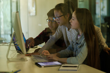 Students using computer at desk