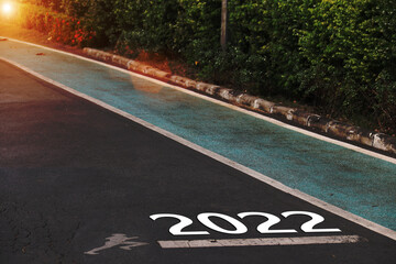 2022 is written on a highway in the middle of an empty paved road. New Year Vision 2022 Ideas