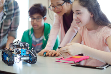 Students playing with robot in classroom