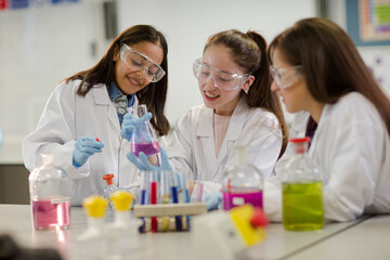 Girl students conducting scientific experiment in laboratory classroom