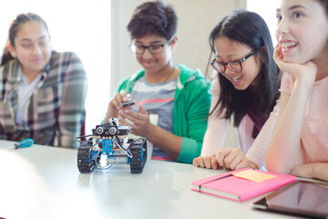 Fototapeta premium Students playing with robot in classroom