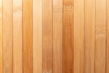 Background made of vertical yellow bamboo laths.texture, background of brown bamboo.