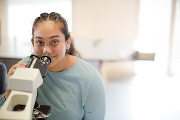 Girl student using microscope in classroom © KOTO