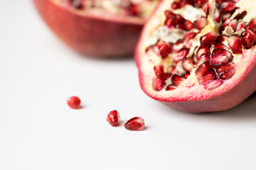 Pomegranate Seeds On White Background Close Up Cut In Half