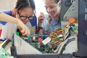 Girl students assembling computer in classroom © KOTO