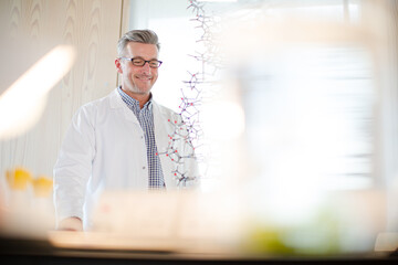 Science teacher assembling molecule model in laboratory classroom