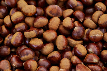 Raw chestnuts displayed in a traditional market