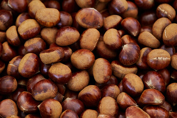 Raw chestnuts displayed in a traditional market