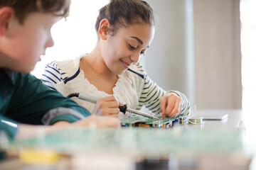 Students assembling computer in classroom