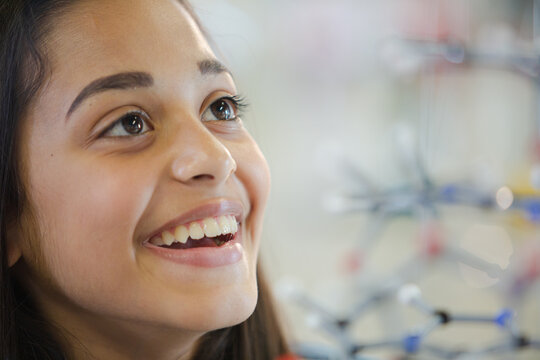 Curious girl student examining molecular structure