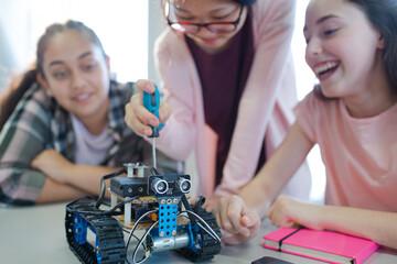 Students playing with robot in classroom