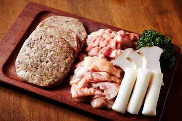 Beef offal and marinated meat on a chopping board