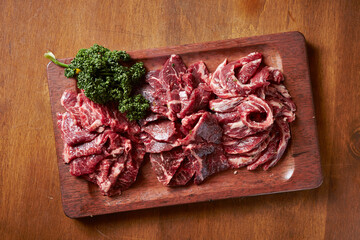 Various cuts of raw beef on a cutting board