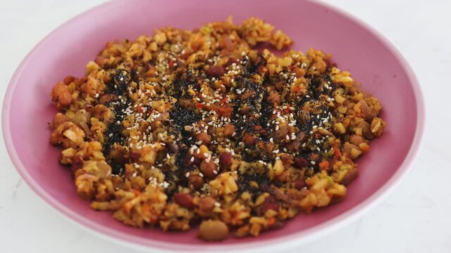 vegan sauteed potato beans and onion dish with seeds topping, healthy plant-based food