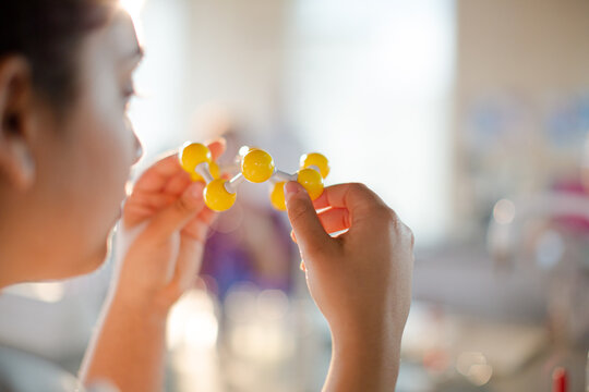 Curious girl student examining molecular structure