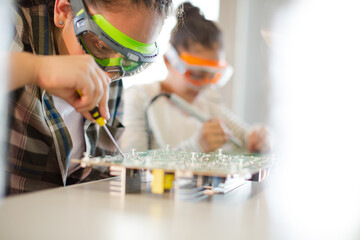 Students assembling computer in classroom © KOTO