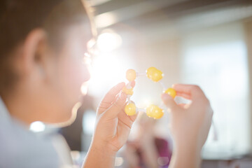 Curious girl student examining molecular structure