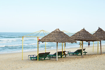 Naklejka na ściany i meble beach chairs and umbrellas on the beach