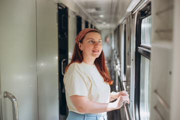 A beautiful hipster woman travelling on the train in Europe. Tourist travel concept.