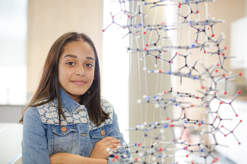 Portrait smiling girl student holding molecular model in laboratory classroom