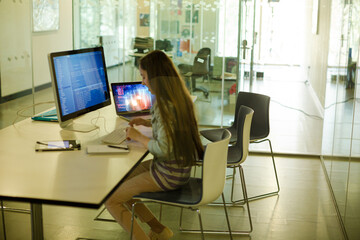 Girl student using computer at desk