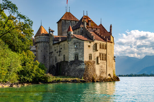SWITZERLAND, MONTREUX, AUGUST 2021 - The Chillon Castle is landmark in Montreux on Geneva Lake against the background of the Swiss Alps at Switzerland