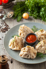 Traditional Georgian dumplings with meat. Khinkali. Served on a plate with traditional Georgian bread.