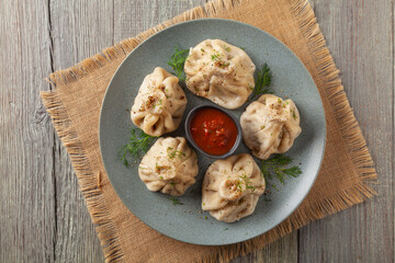 Traditional Georgian dumplings with meat. Khinkali. Served on a plate with traditional Georgian bread.