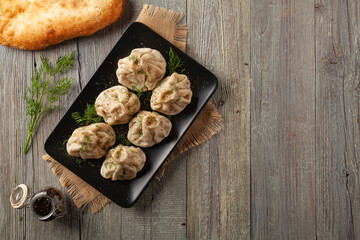 Traditional Georgian dumplings with meat. Khinkali. Served on a plate with traditional Georgian bread.