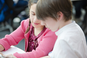 Students using digital tablet in library