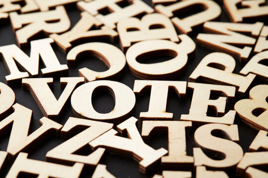 The word 'vote' between wooden letters
